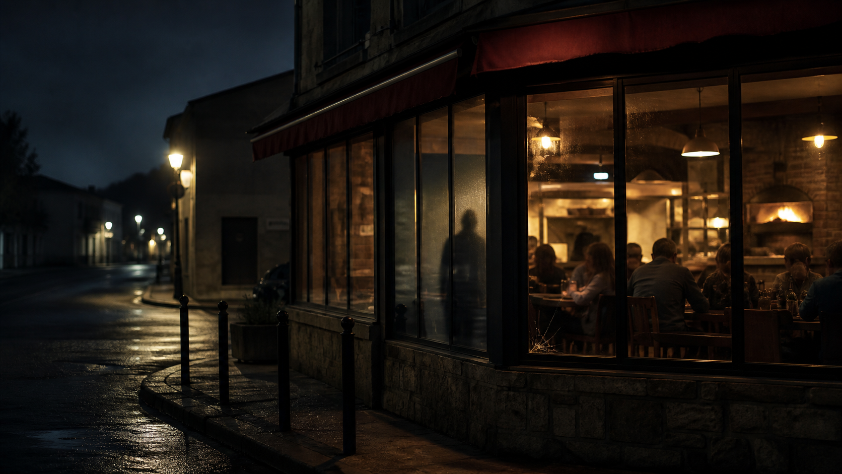 Une pizzeria familiale éclairée dans une rue sombre de Saint-Estève